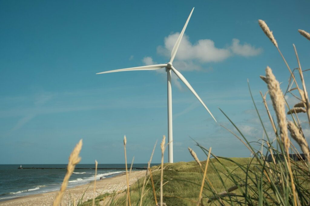 A wind turbine on a beach near the ocean
